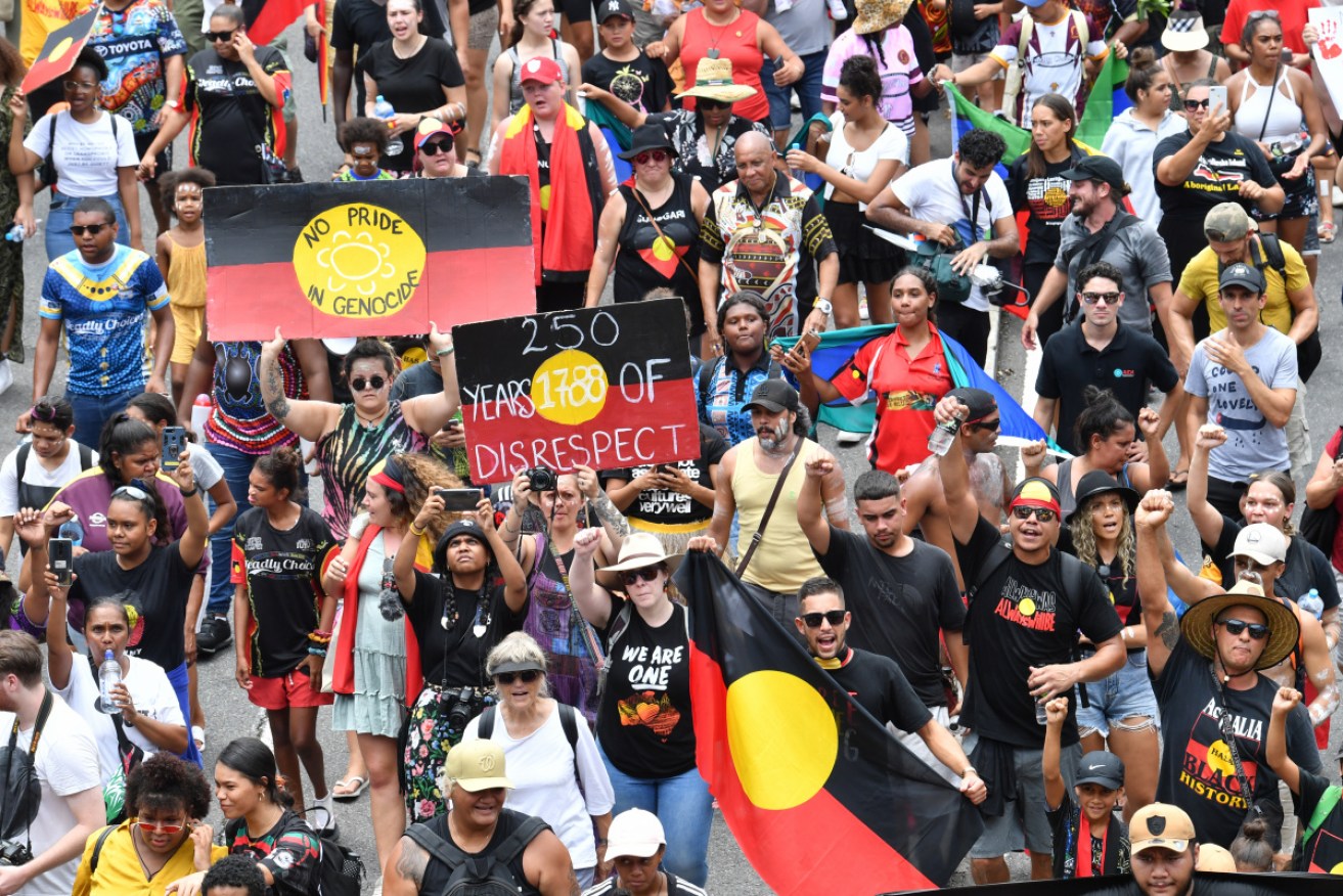 Protesters cross the Victoria Bridge during the Invasion Day rally in Brisbane on January 26, 2020.