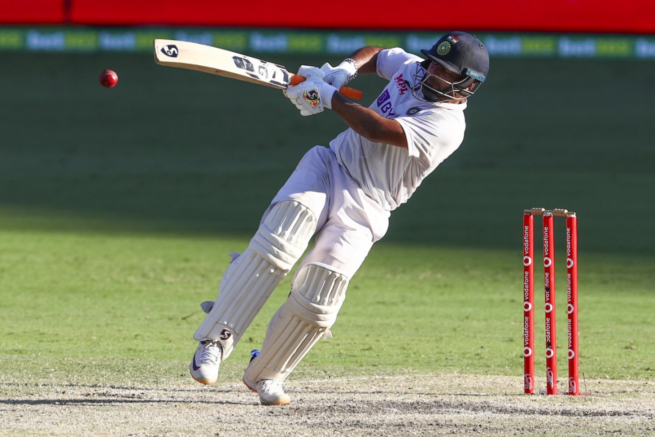 India's Rishabh Pant falls as he hits a boundary late on the final day of the fourth Test at the Gabba on Tuesday.