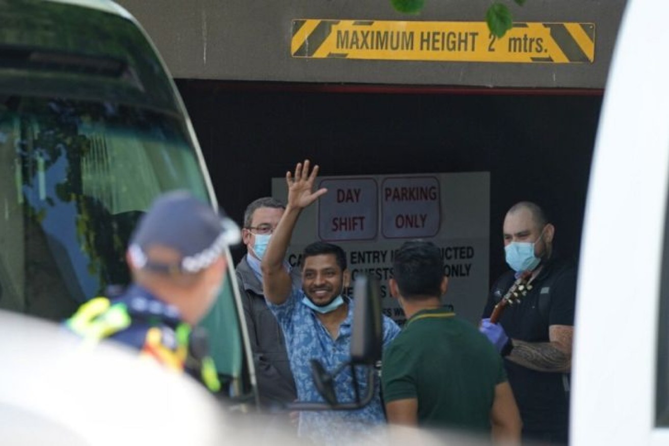A refugee waves as he leaves the Park Hotel in Melbourne earlier in 2021.
