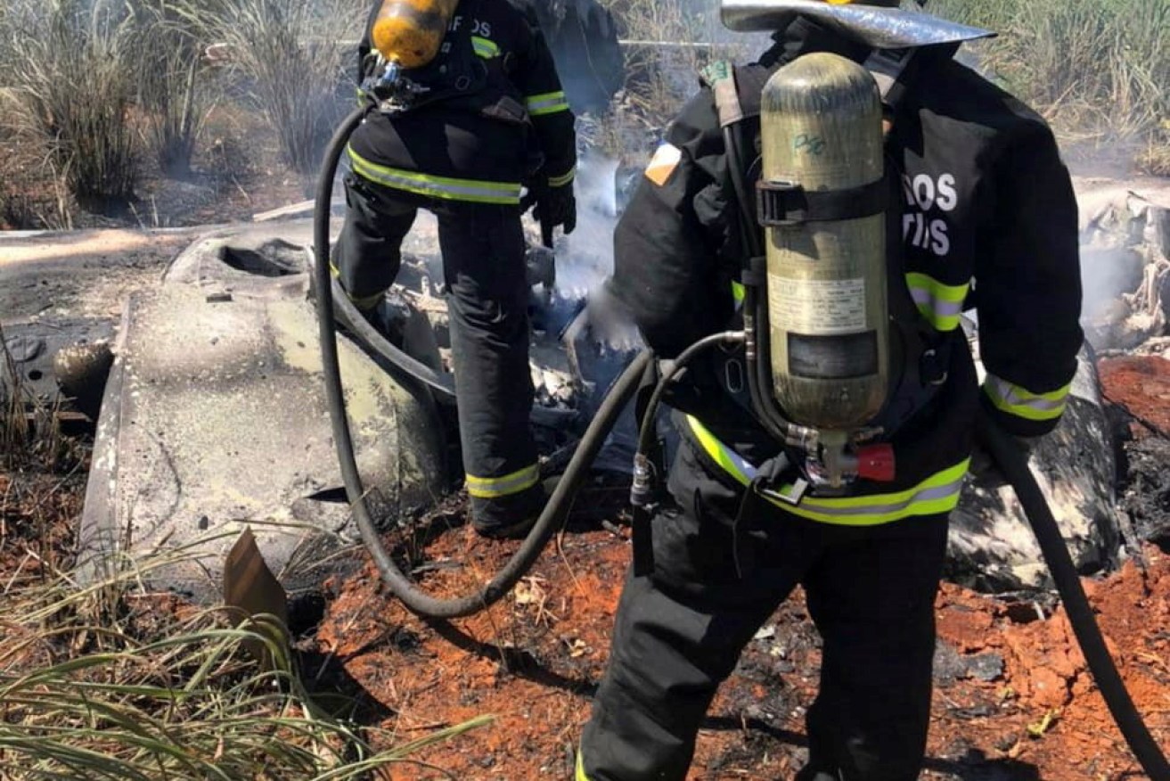 Tocantins State Firefighters in the area where a plane crashed near Palmas, Tocantins state, central Brazil on January 24.