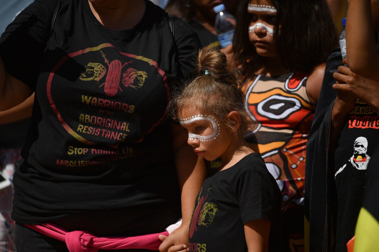A family participating in an 'Invasion Day' rally in 2019. 