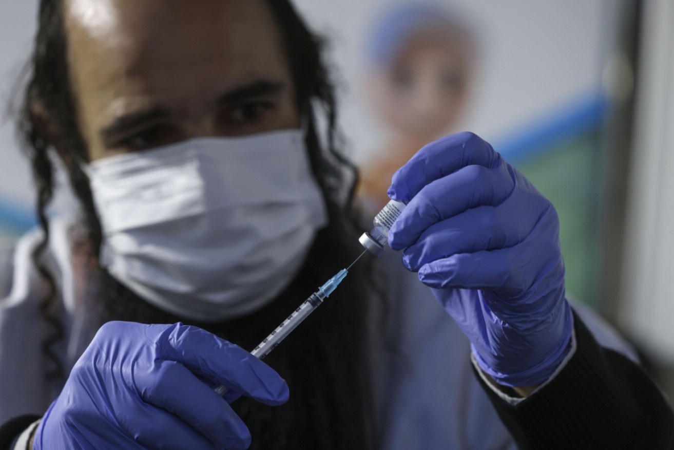 An Israeli health worker prepares a dose of the Pfizer/BioNtech COVID-19 vaccine in Jerusalem.