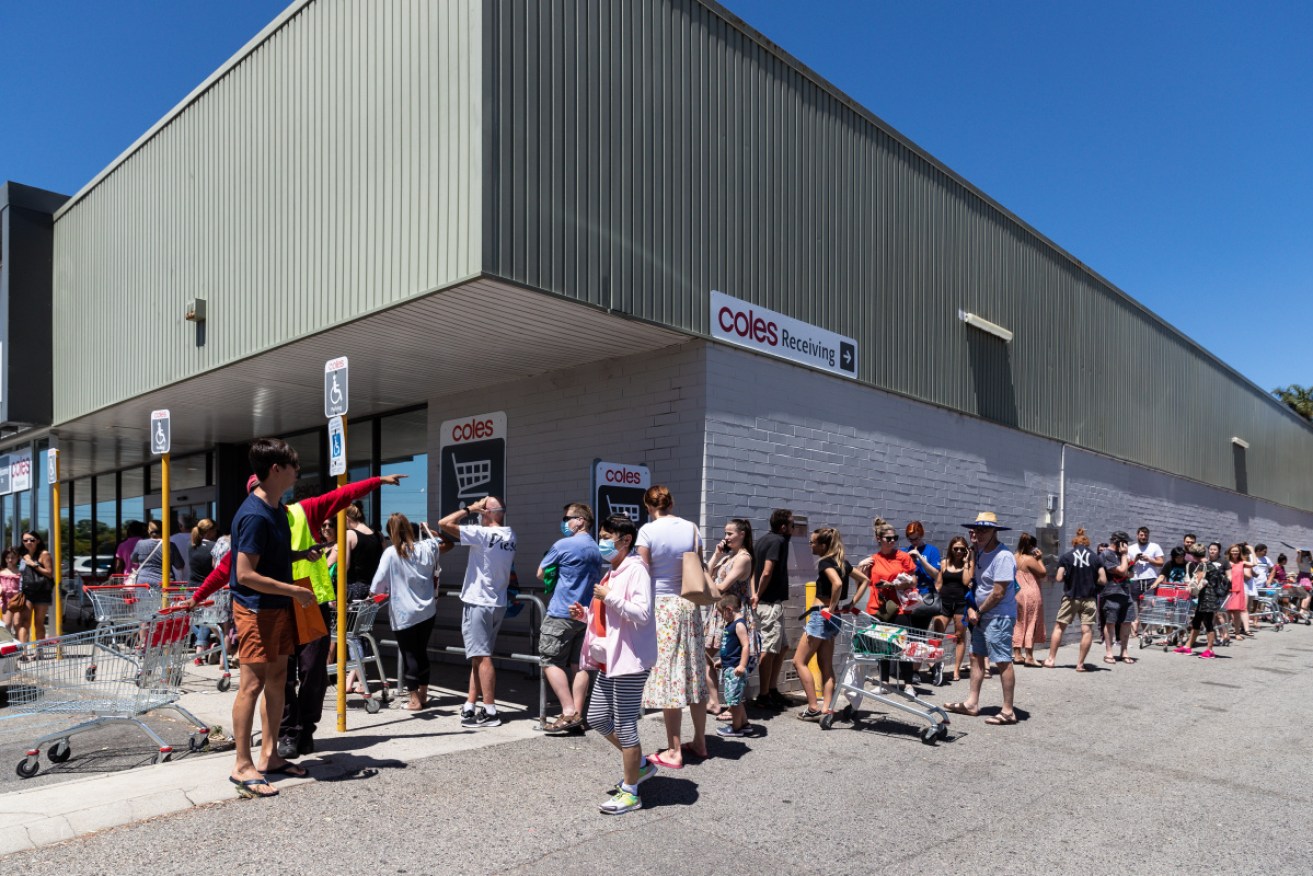Panic buying: Shoppers queue to buy supplies at a Perth supermarket. 