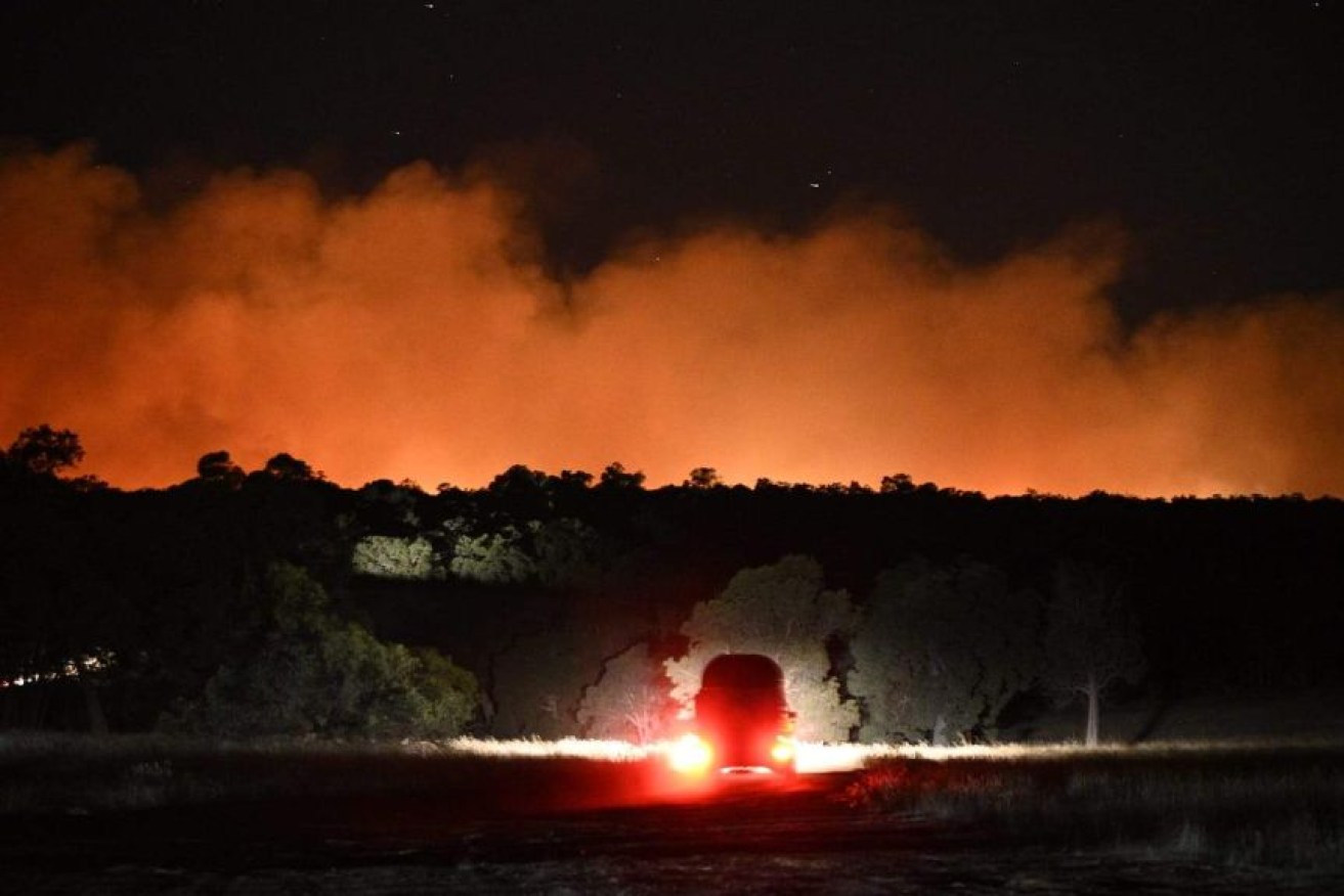 The night sky was turned orange overnight as "horrific" bushfire conditions left properties at risk. 