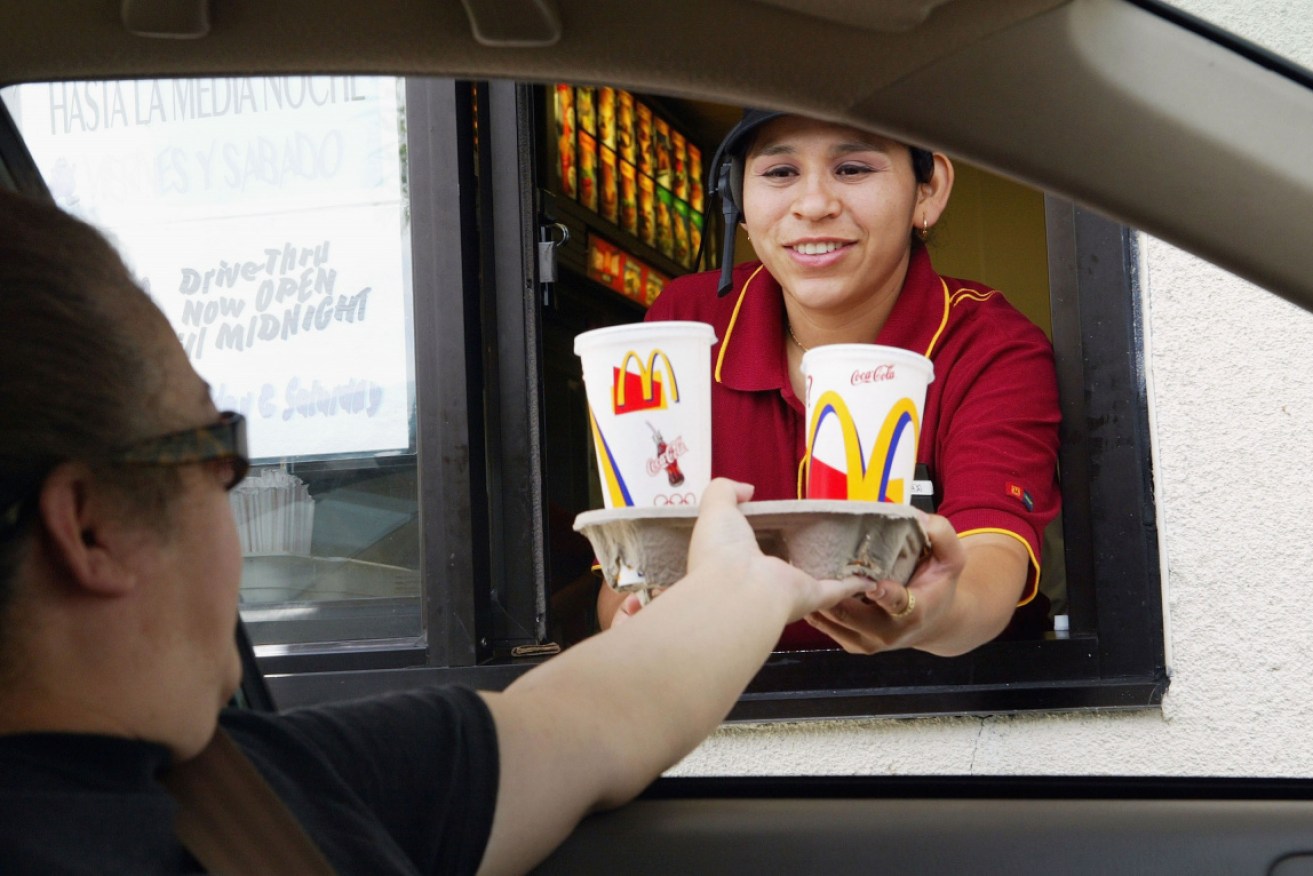 Humans will continue to take orders at McDonald's drive-throughs for now.