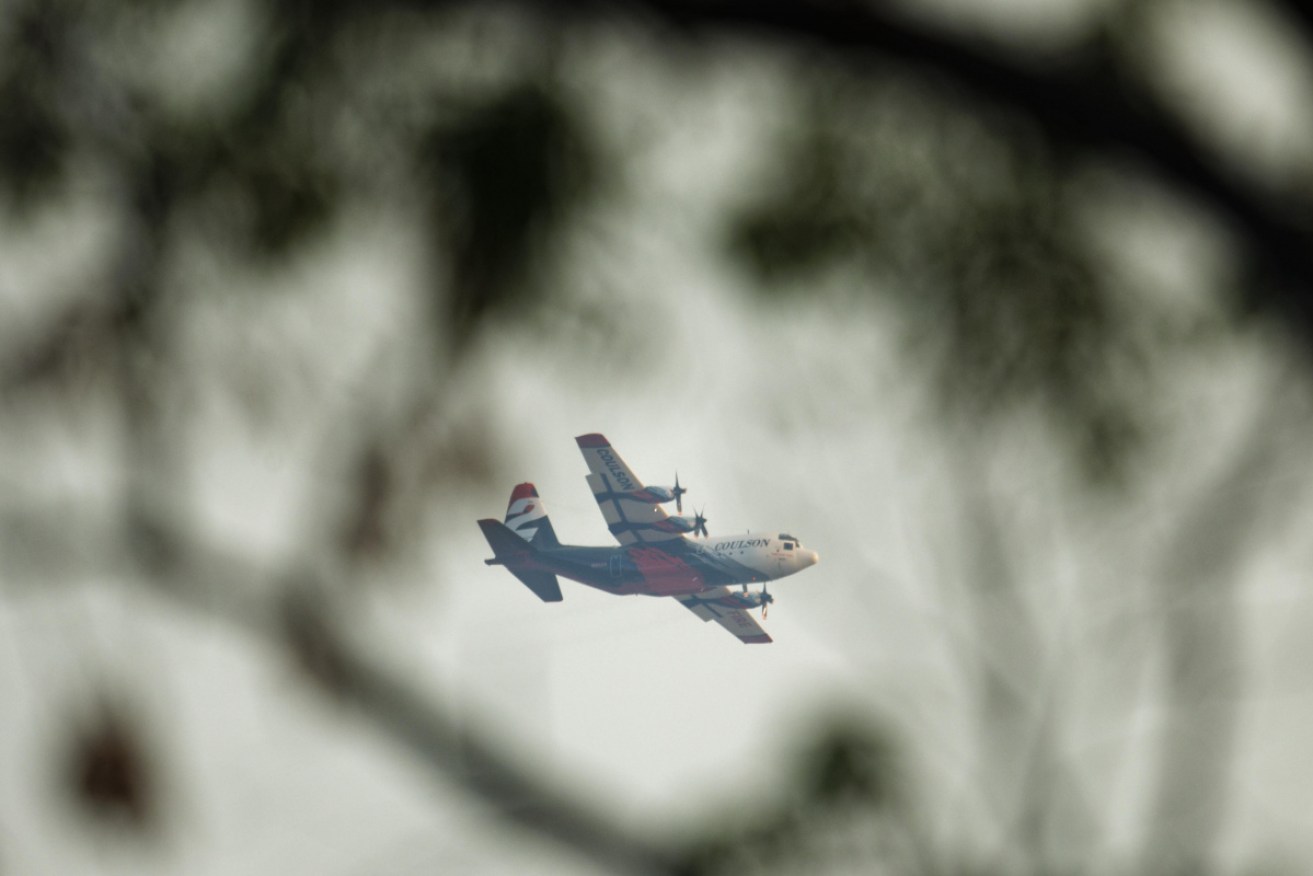 Water-bombing aircraft have dropped fire retardant, helping to slow the spread of the blaze.