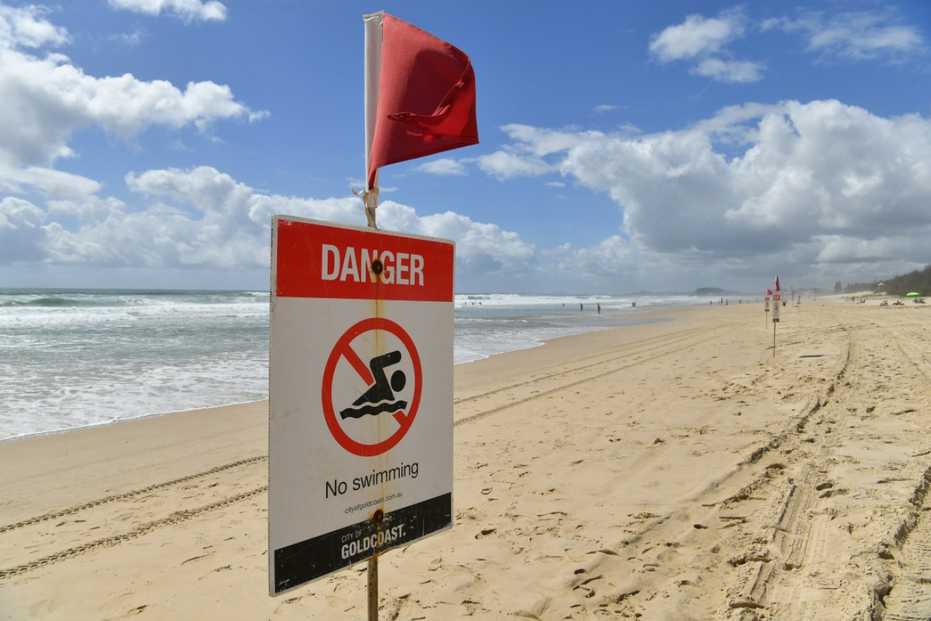 The body of the man was recovered after a woman drowned following a late-night swim in big surf on the Gold Coast.