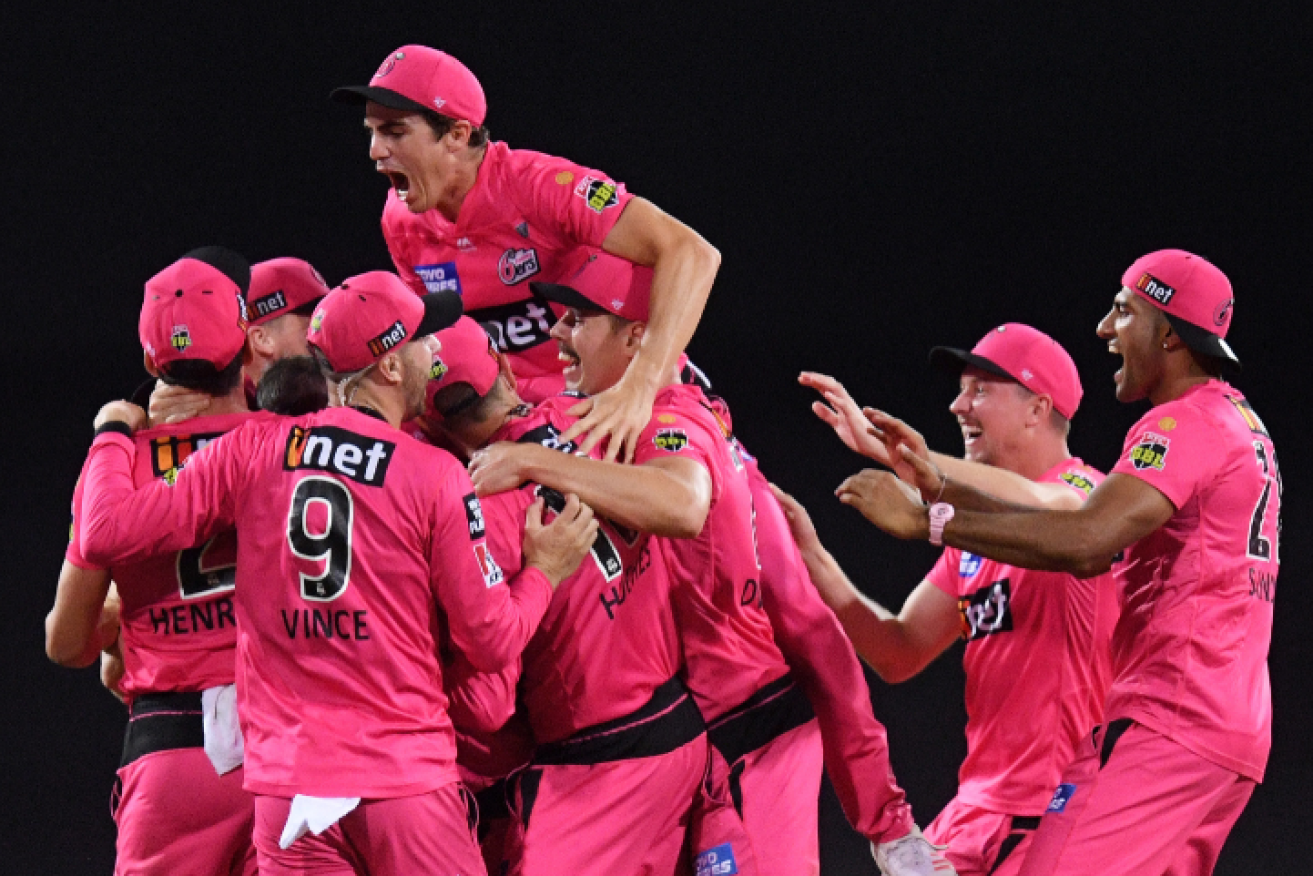 The victorious Sixers fall into each other's arms after dashing the Scorchers' hopes.