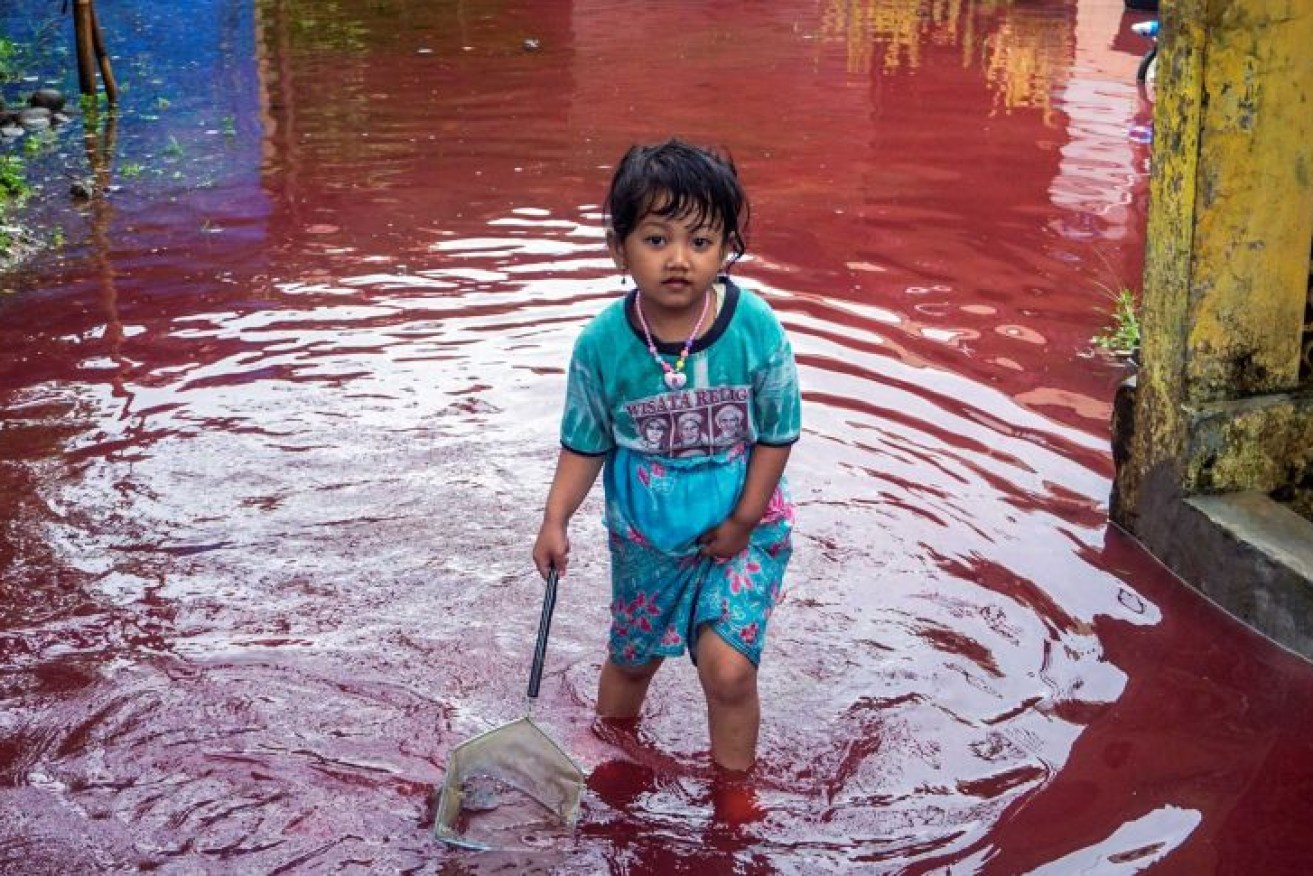 Dye has turned floodwaters red. Photo: Reuters 