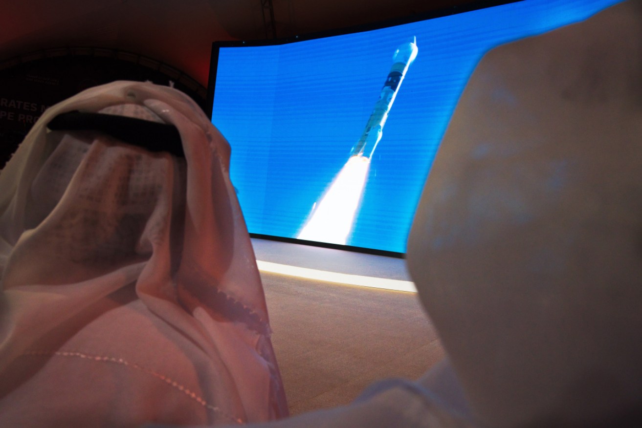 Men watching "Amal" or "Hope" space probe at the Mohammed bin Rashid Space Center in Dubai, United Arab Emirates, when it launched in July. 