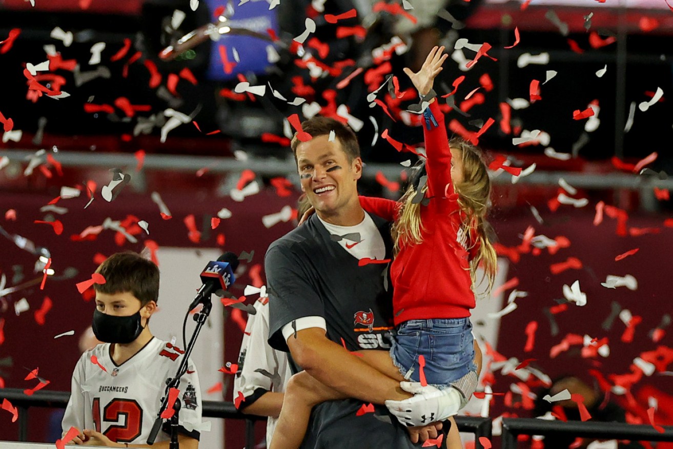 Tom Brady celebrates with daughter Vivian after winning Super Bowl LV on Monday (AEDT).