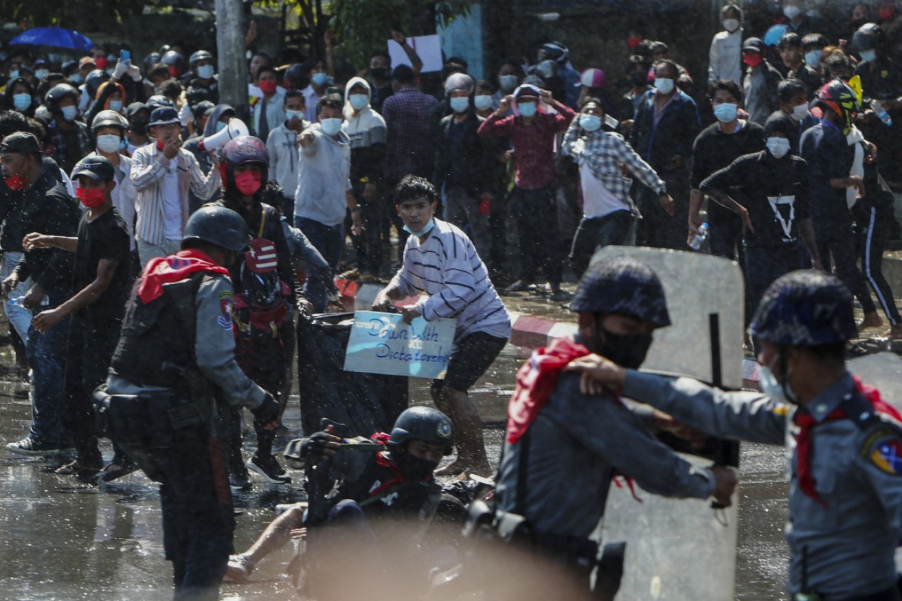 Protestors scatter after gunshots at a protest in Myanmar.