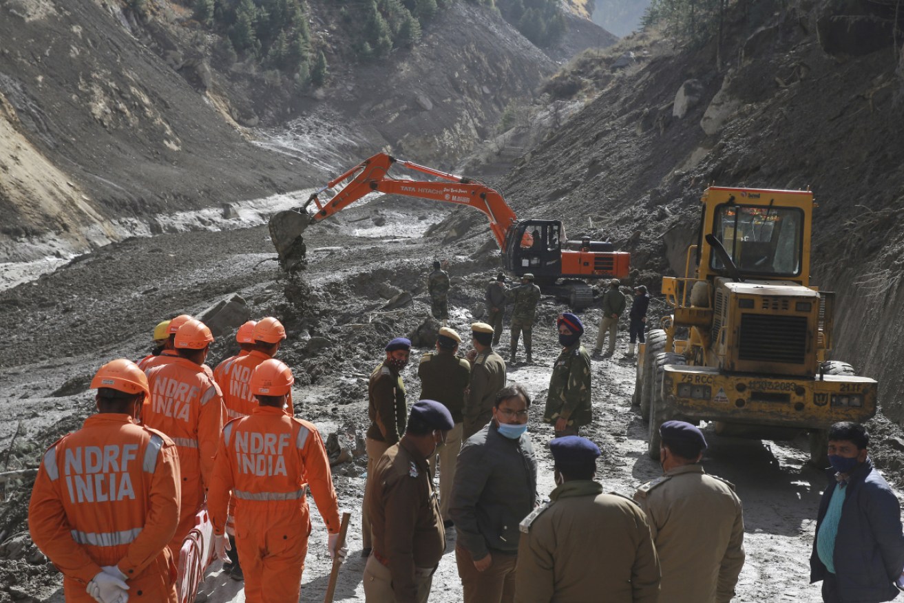 National Disaster Response Force (NDRF) personnel clear debris after a portion of the Nanda Devi glacier snapped off.