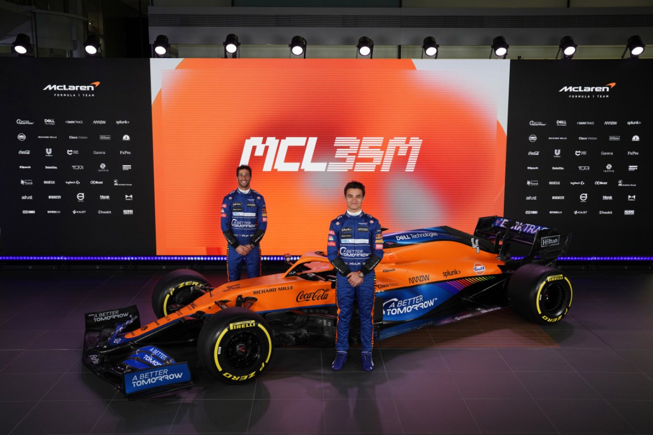 Daniel Ricciardo and teammate Lando Norris with the new McLaren F1 racer. 