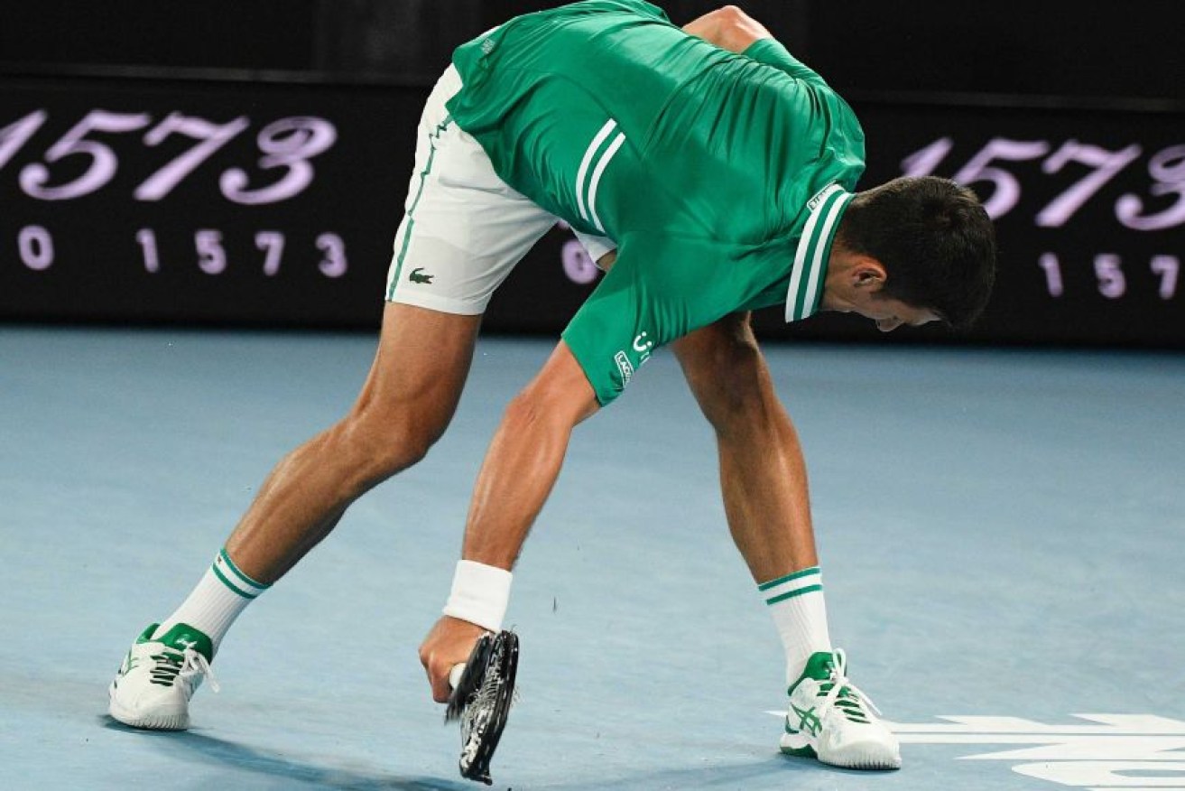 Novak Djokovic smashes his racquet during his quarter-final against Alexander Zverev.