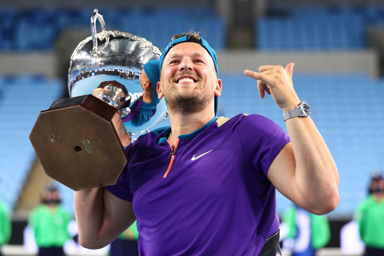 Dylan Alcott poses with the championship trophy after winning his Quad Wheelchair Singles Final match against Sam Schroder.