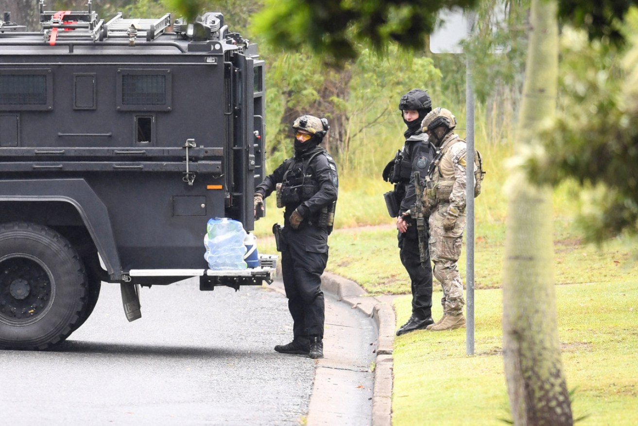 Heavily armed police at the scene of the siege on Friday. 