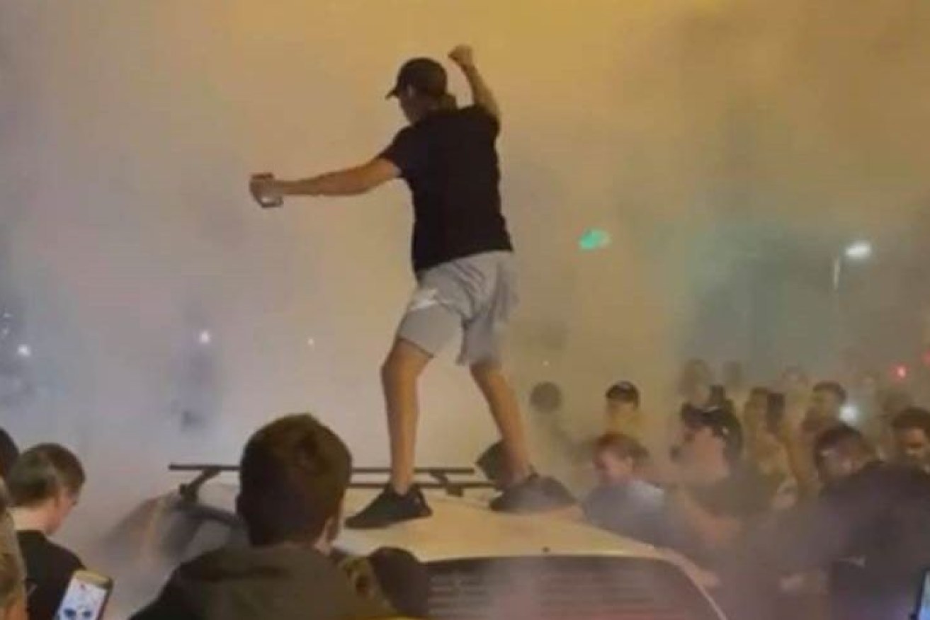 Photos posted to social media showed a man standing on a car during the meet-up.