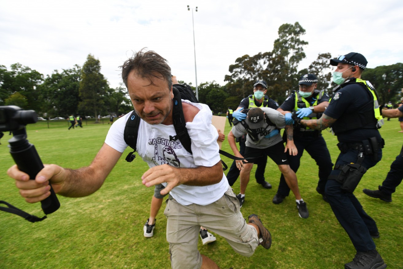 Police arrest a protester during an anti-vaccination rally in Melbourne.