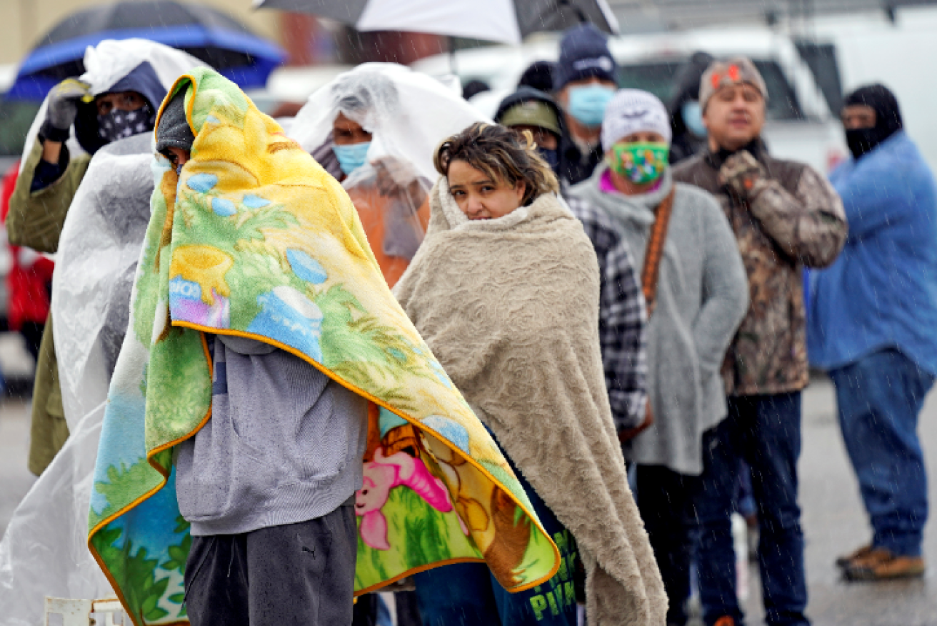 Wrapped in blankets against the bitter cold, Texans line up for propane to keep their homes heated and habitable.