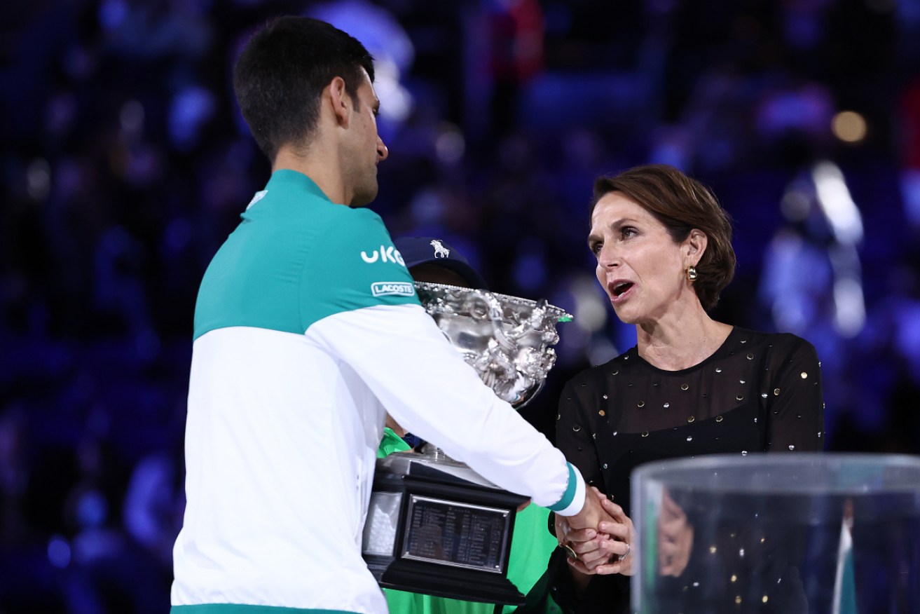 Jayne Hrdlicka presents Australian Open men's champion Novak Djokovic with his trophy on Sunday night.