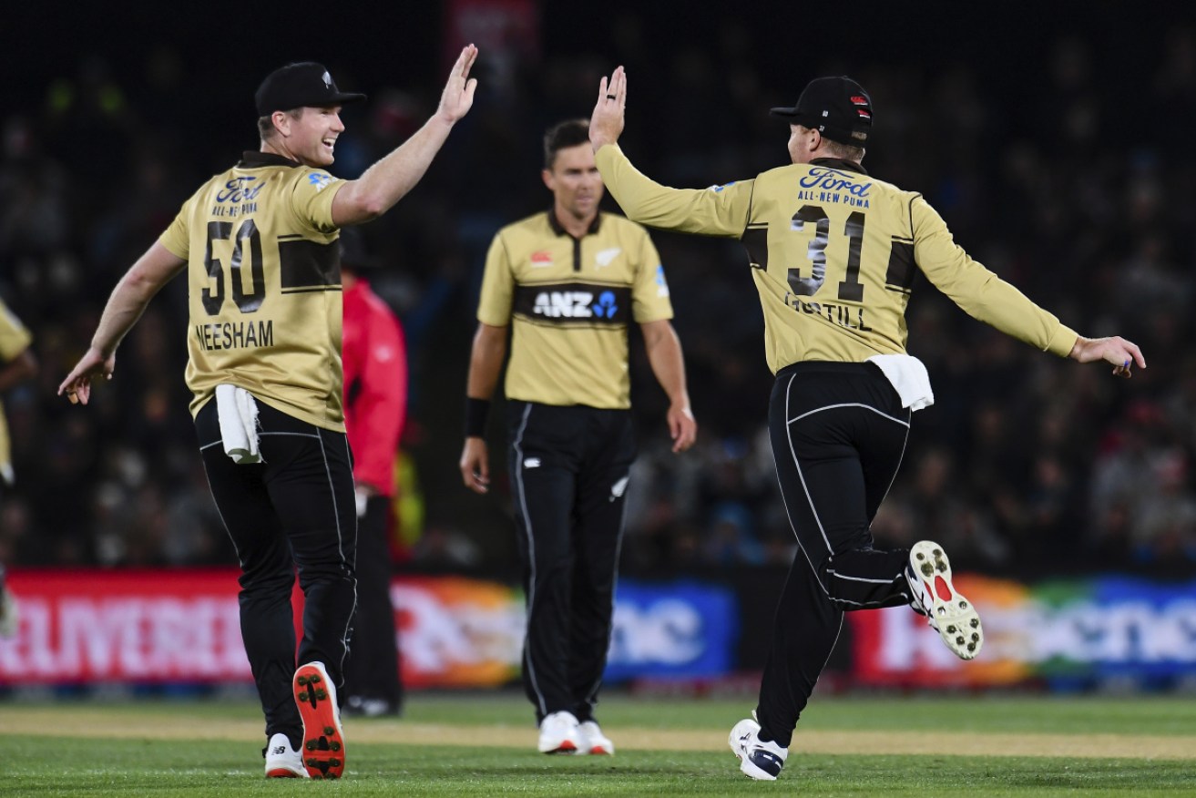 New Zealand duo James Neesham and Martin Guptill celebrate the wicket of Australia's Matthew Wade in Christchurch on Monday night.