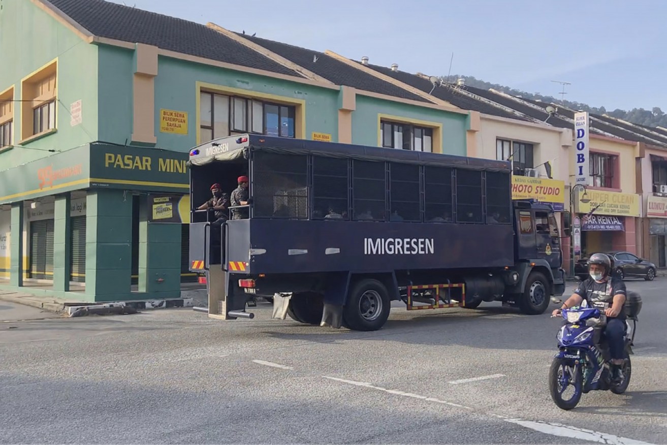A video screenshot shows an immigration truck with security and unidentified people on its way to Lumut Naval Base on Tuesday.