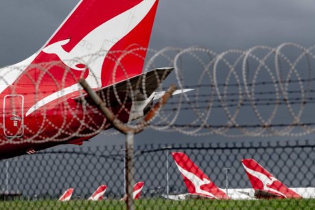 Qantas posts $1 billion six-month loss