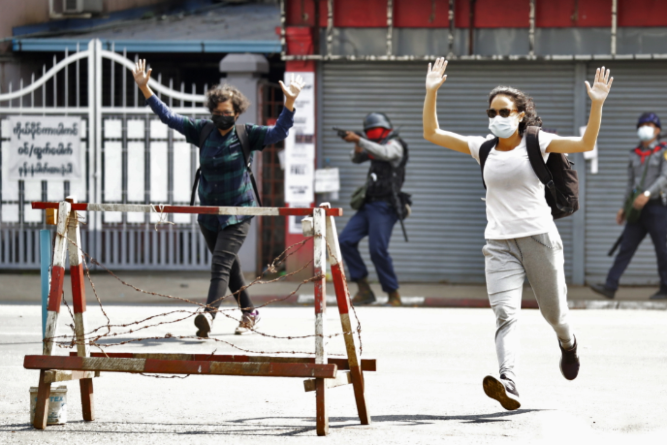 Protesters surrender in Yangon at the point of a gun.