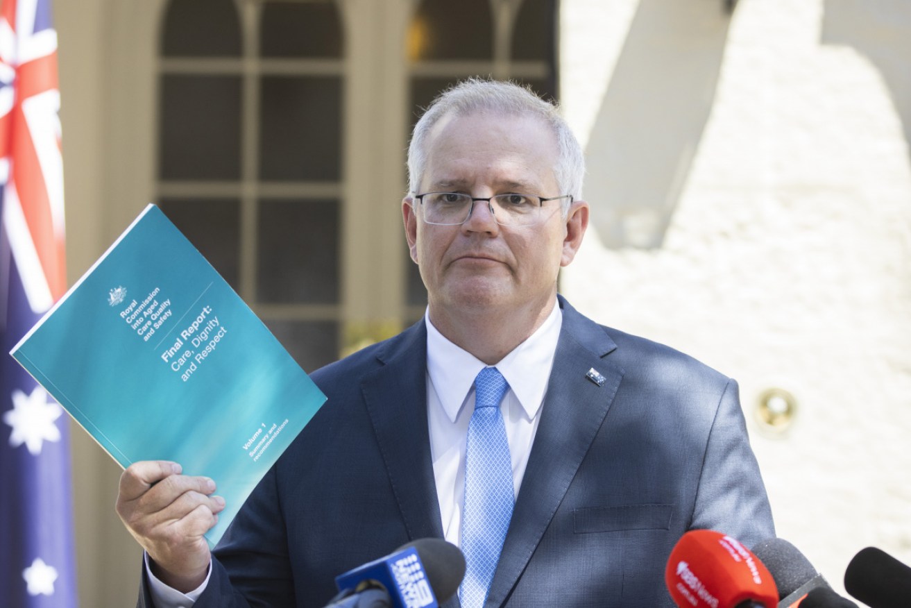 Scott Morrison holds the Final Report after Royal Commission into Aged Care Quality and Safety. 