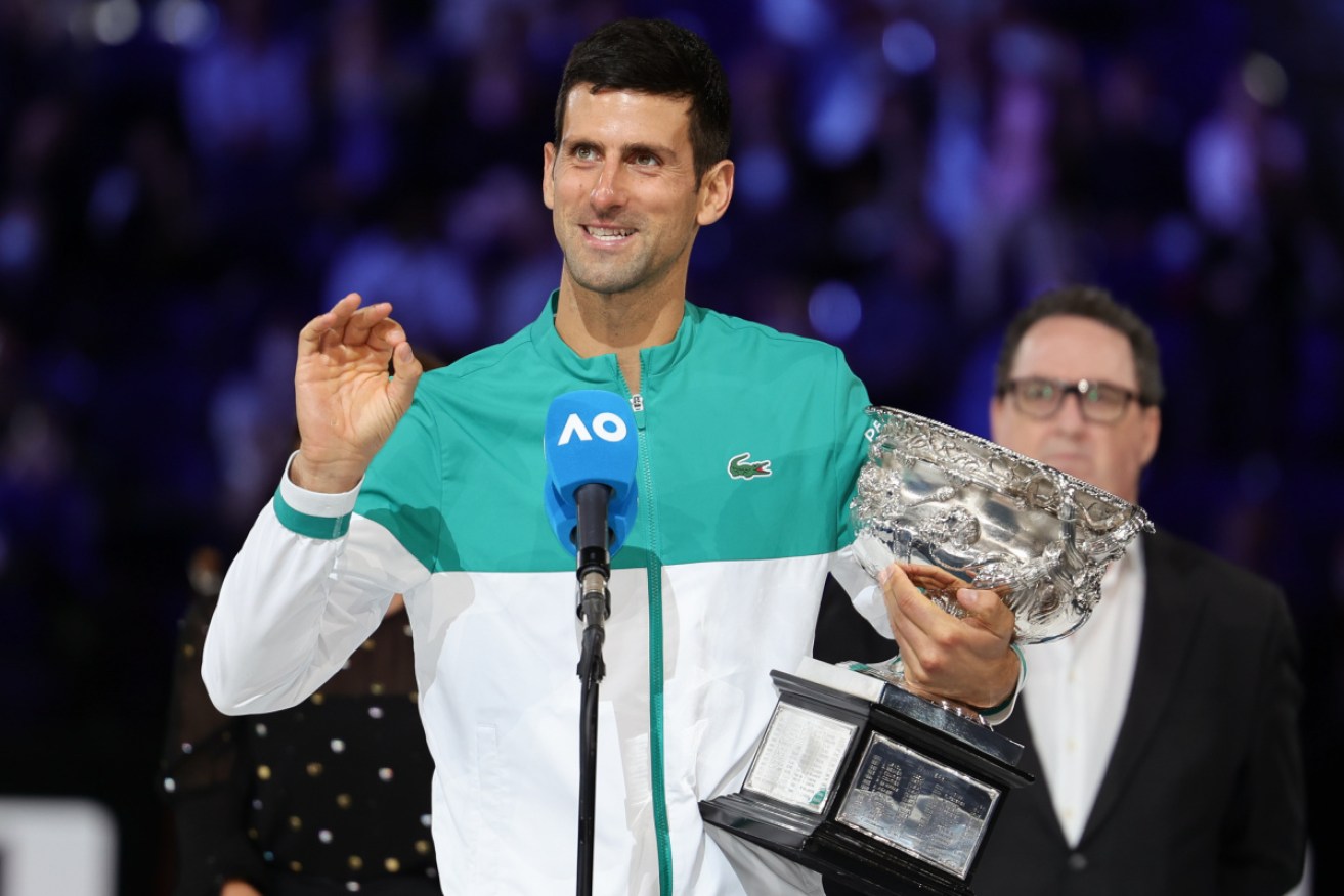 Top seed Novak Djokovic poses with his latest Australian Open trophy.