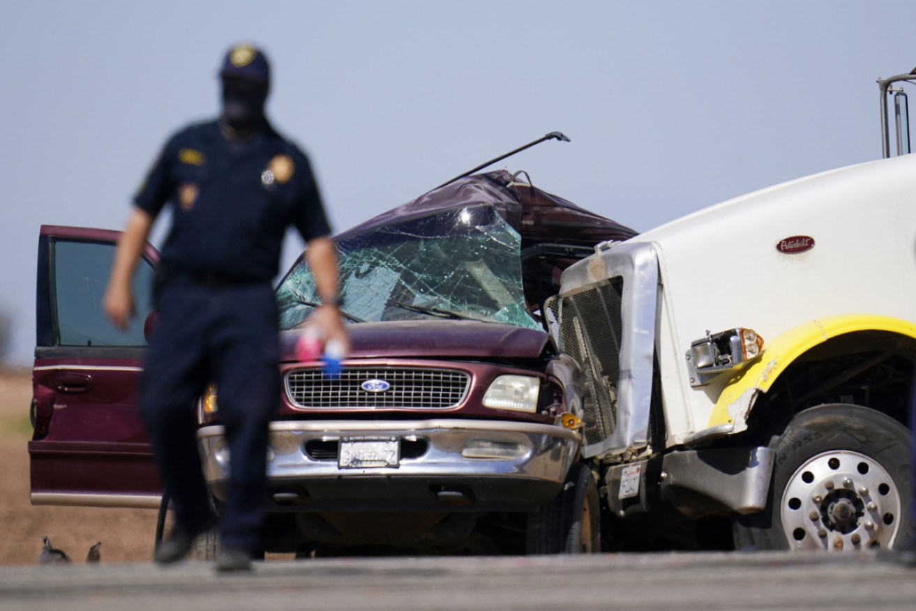 Police at the scene of the deadly crash between a semi-trailer and a 4WD.