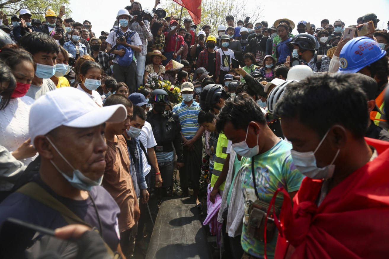 People gather around the coffin of Ma Kyal Sin during her funeral in Mandalay, Myanmar on Thursday.