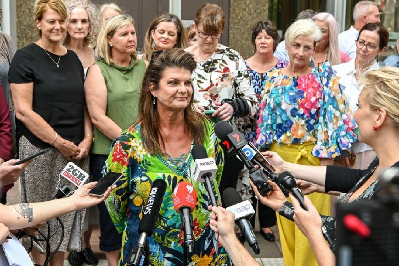 Julie Davis, centre, surrounded by other women involved in the class action suit outside court after the initial verdict.