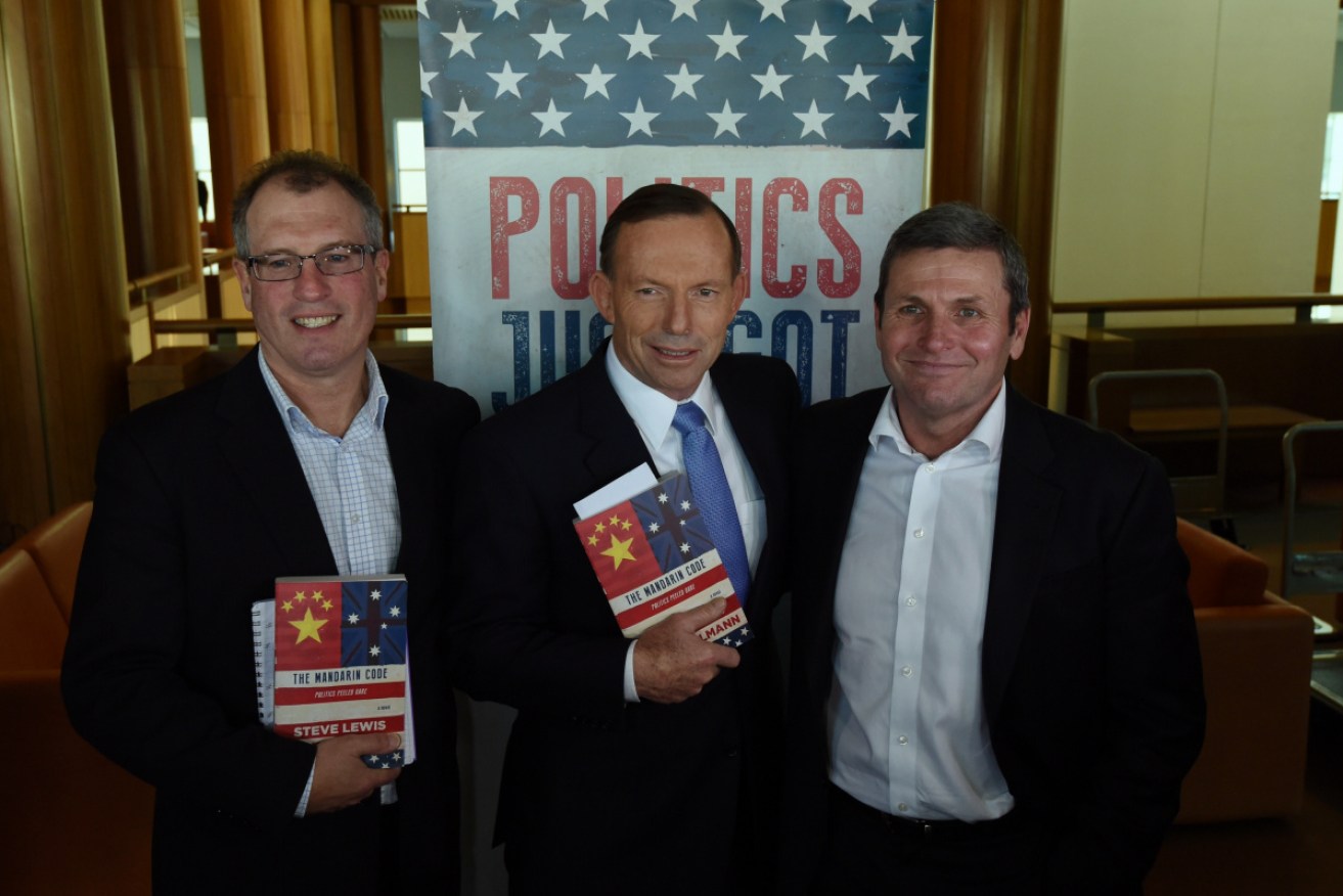 Chris Uhlmann (right) at a book launch with his co-author Steve Lewis and then PM Tony Abbott in 2014.