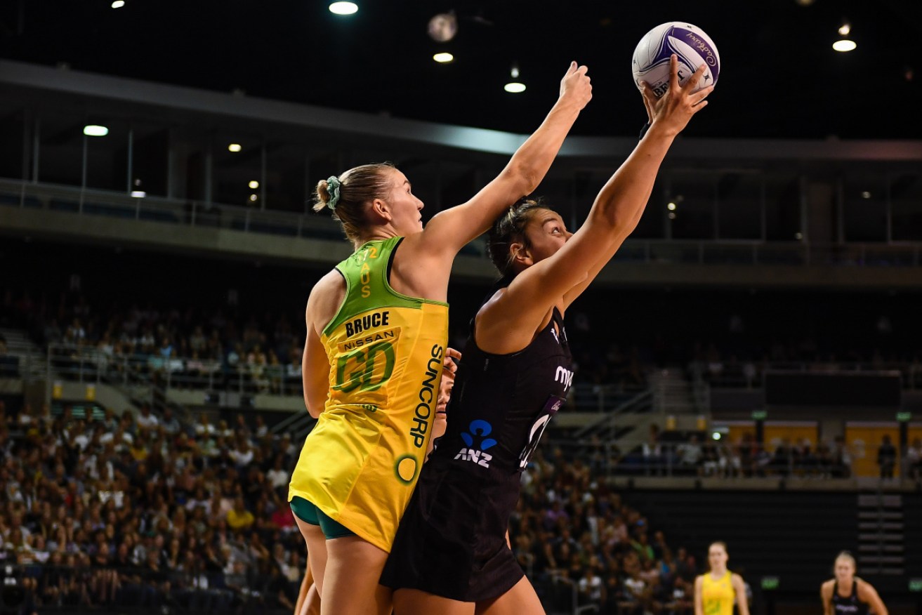 Maia Wilson of the Silver Ferns takes possession under pressure from Courtney Bruce on Sunday.  