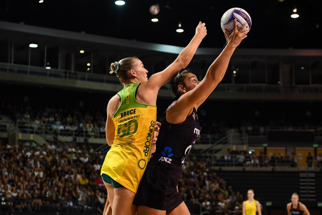 Maia Wilson of the Silver Ferns takes possession under pressure from Courtney Bruce on Sunday.