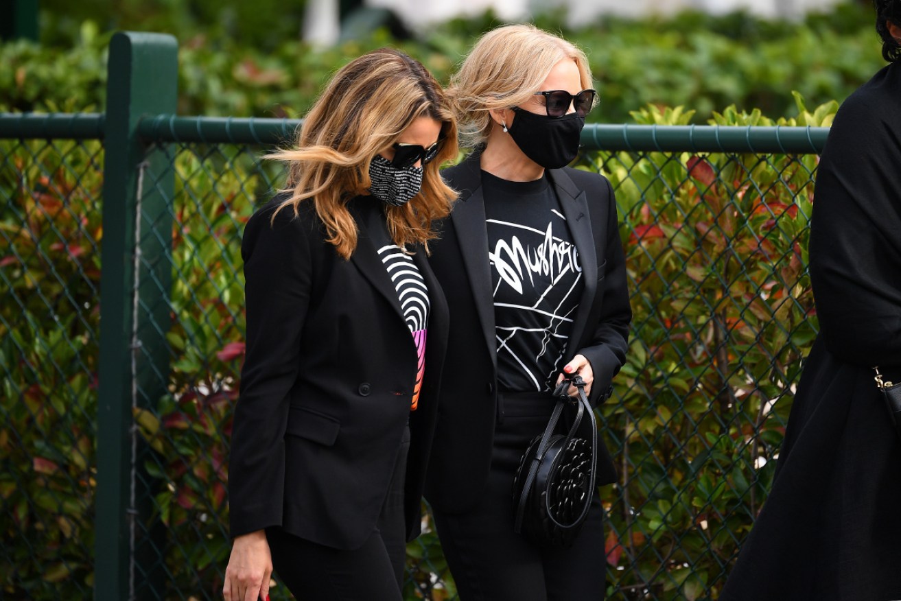 Dannii (left) and Kylie Minogue joined the crowd at the funeral. 