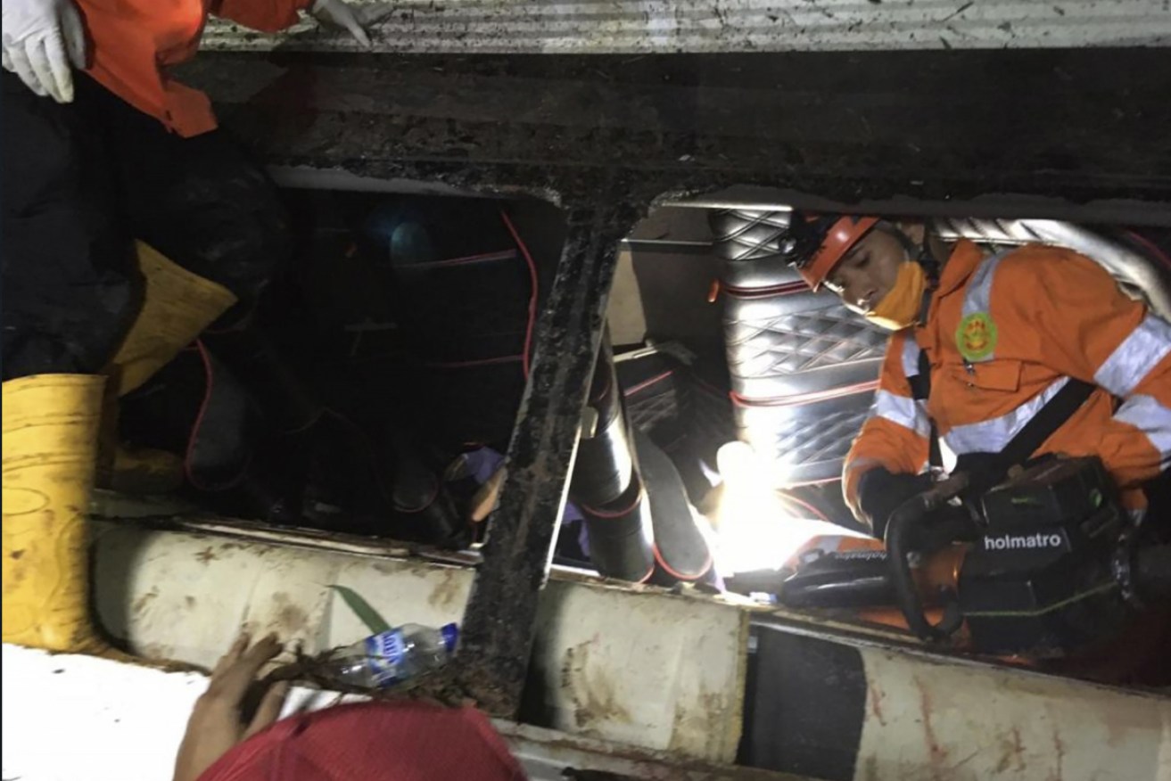 Rescuers search for survivors and victims inside the wreckage of a bus that plunged into a ravine in Sumedang district, Indonesia.