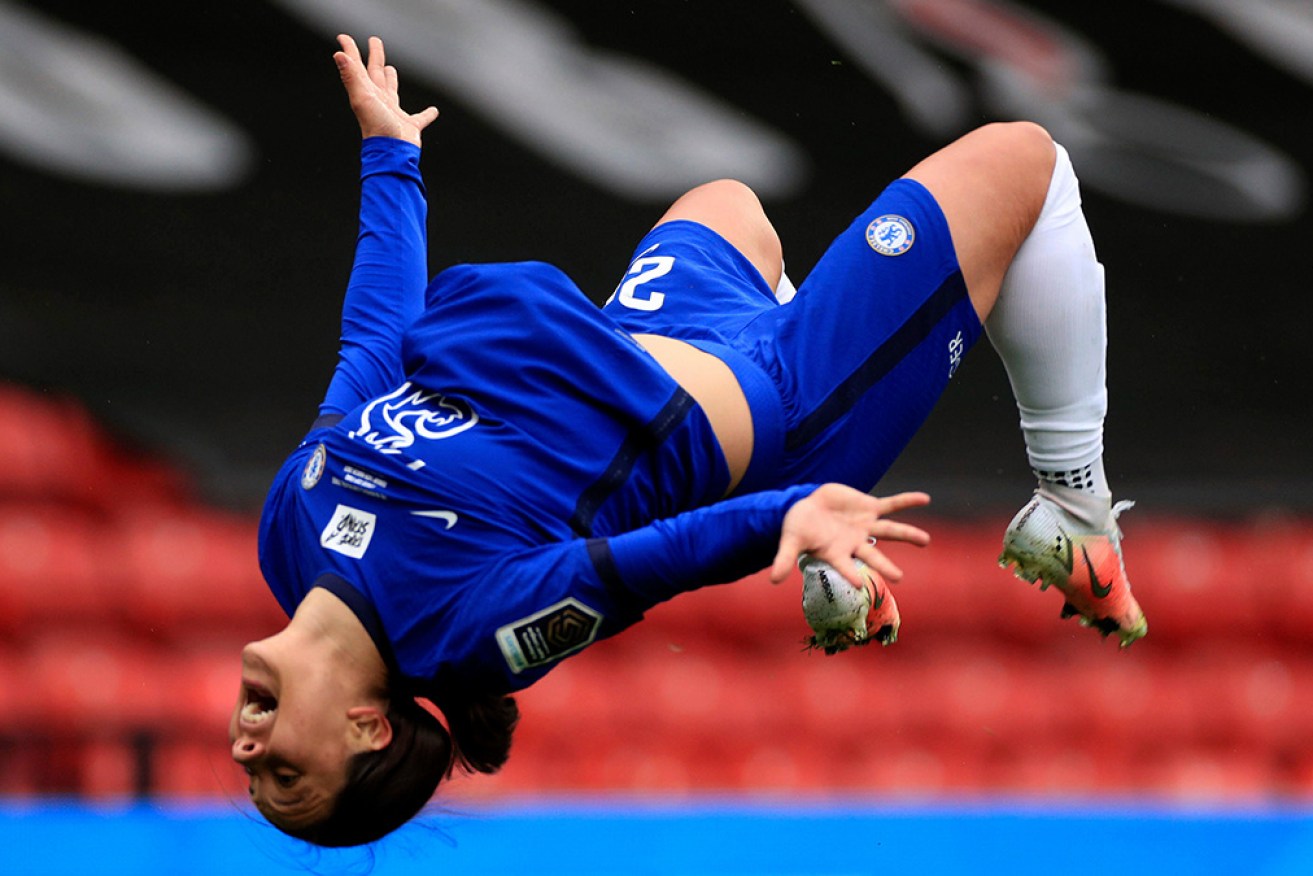Sam Kerr performs a backflip as Chelsea lifts Cup. 