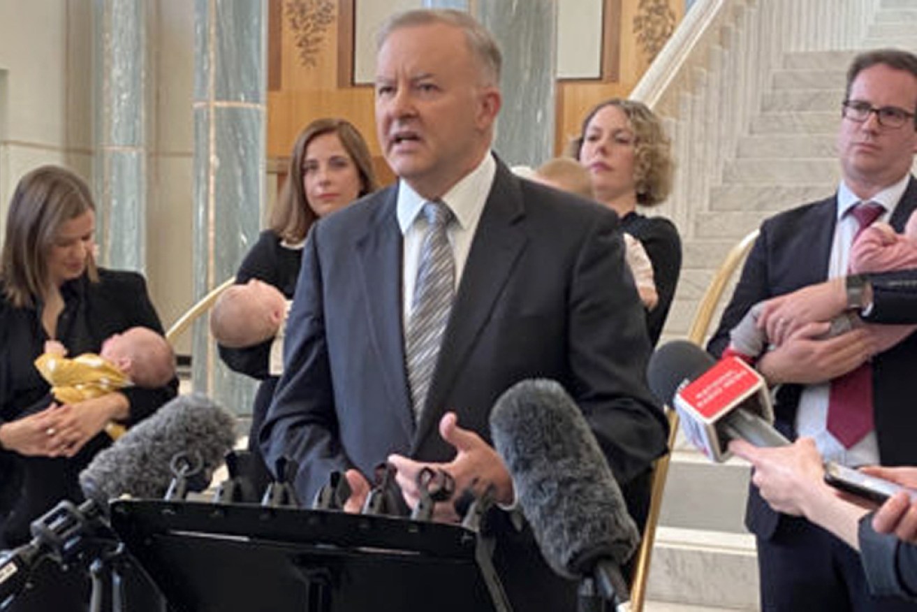 Anthony Albanese surrounded by Labor MPs and babies at his press conference on Monday.