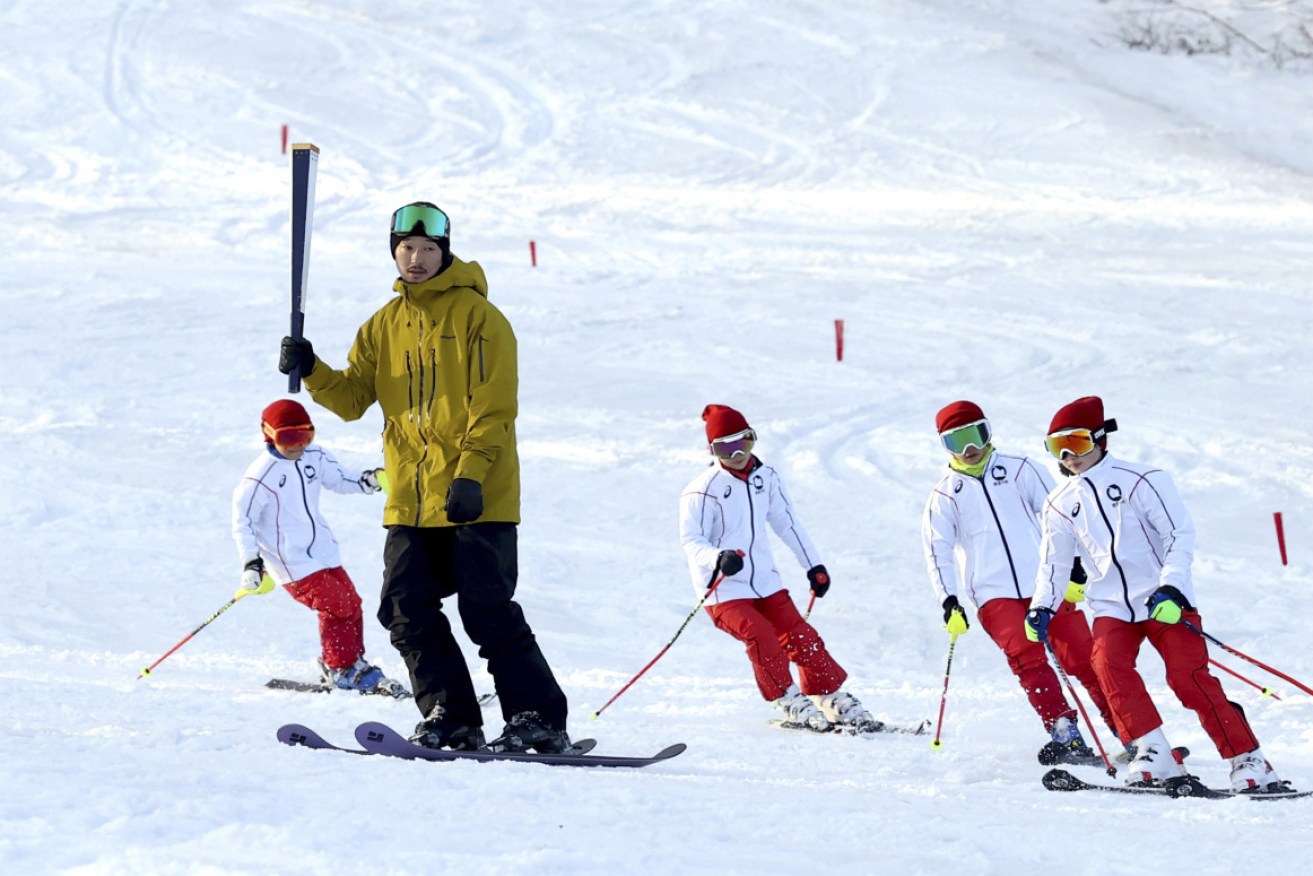 Freestyle skier Sho Endo rehearses for the torch relay at Inawashiro Ski Resort.