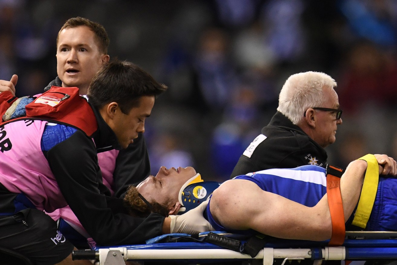 North Melbourne’s Ben Brown is treated for concussion in Melbourne in August 2017.