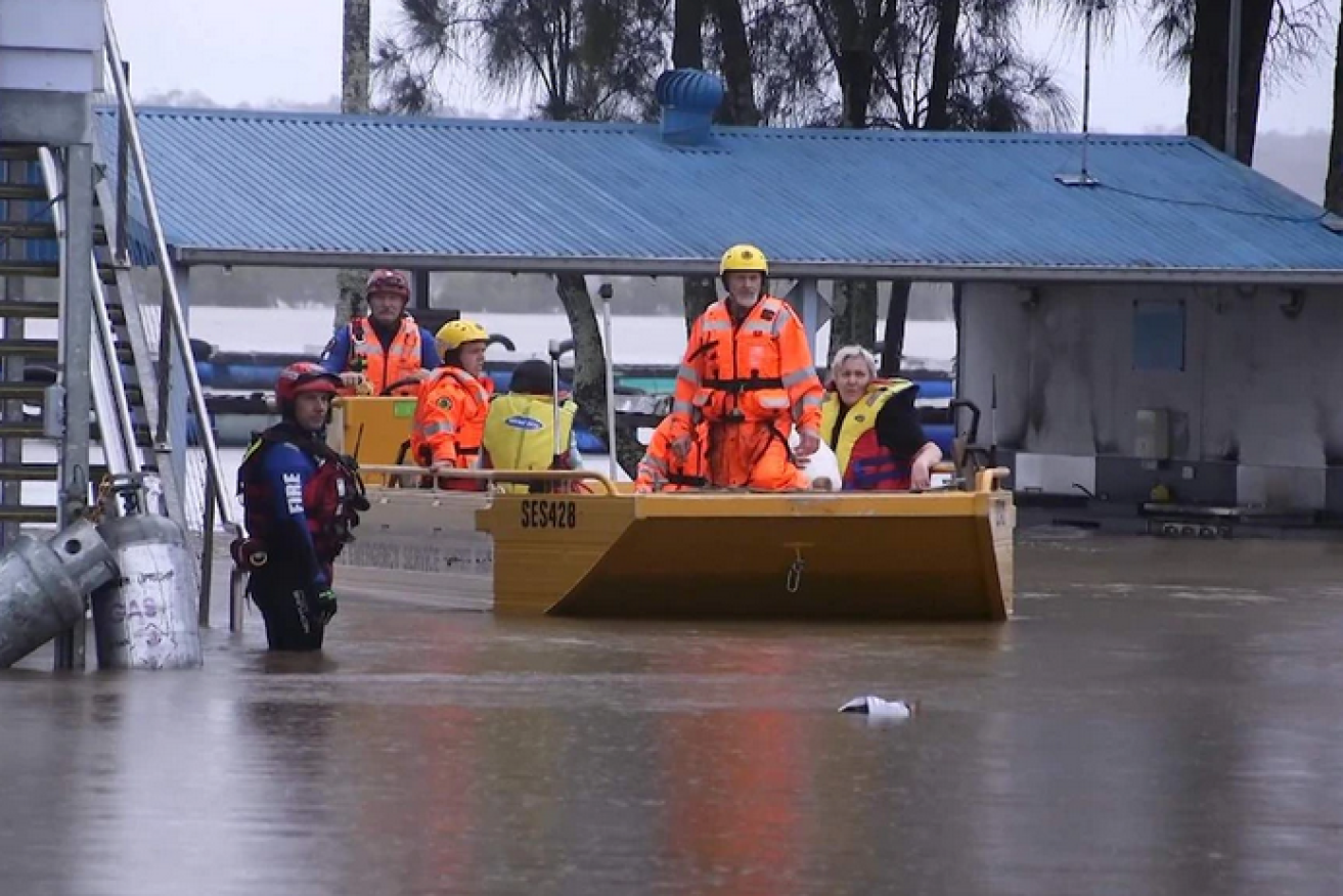 SES volunteers ferry residents from the Pelican Caravan Park in Nambucca.
