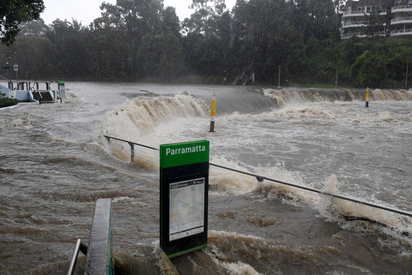 The swollen Parramatta River breaks its banks at the Charles St weir and ferry wharf in Sydney.