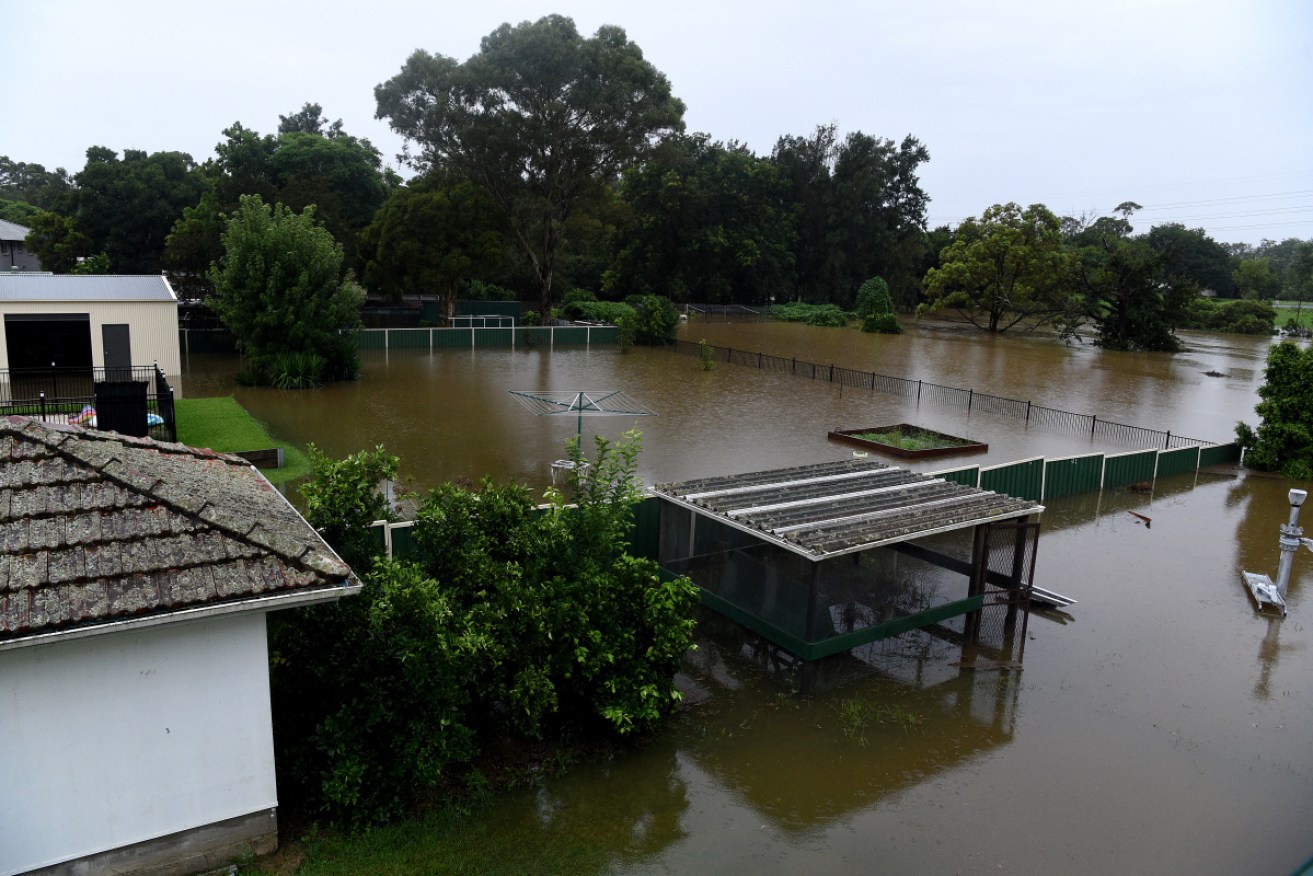 Floodwater completely submerges the backyards of properties on Ladbury Ave, in Penrith, NSW.