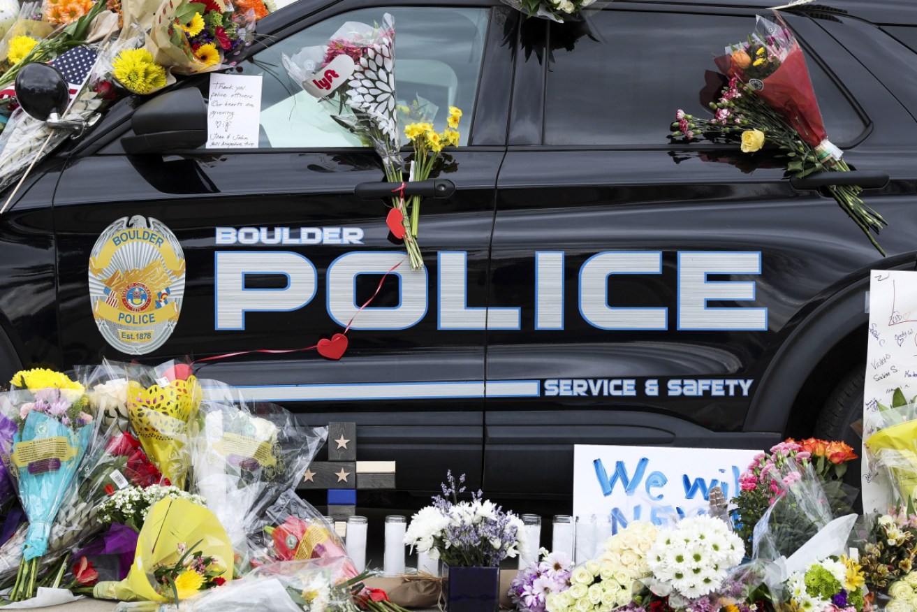 Flowers sit on a Boulder Police vehicle outside the Boulder Police Department.