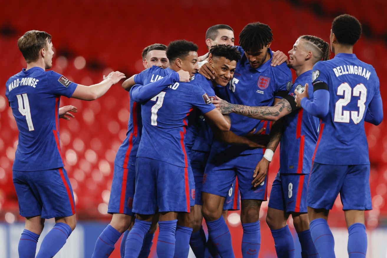 England's Ollie Watkins, centre, is congratulated by teammates after scoring his team's fifth goal.