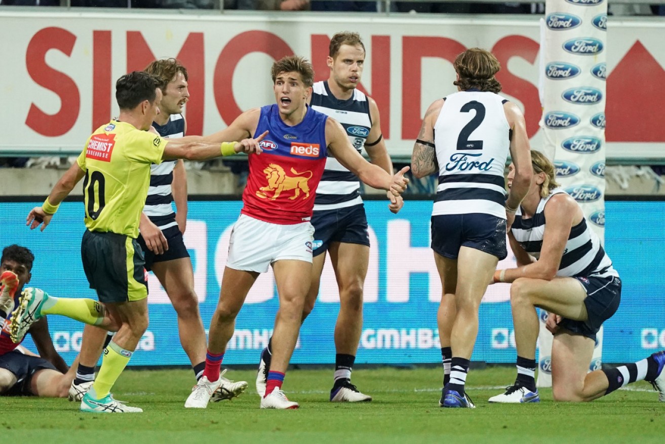 Lion Zac Bailey appeals to the umpire for a holding the ball decision against Geelong's Mark Blicavs. 