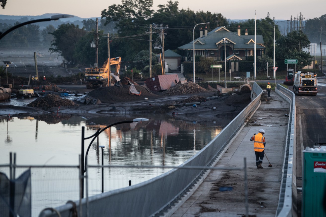 Workers clearing debris from the New Windsor Bridge which was underwater during the recent floods. 